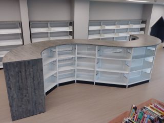 Low height, library bookcases that are curved for an interesting aesthetic